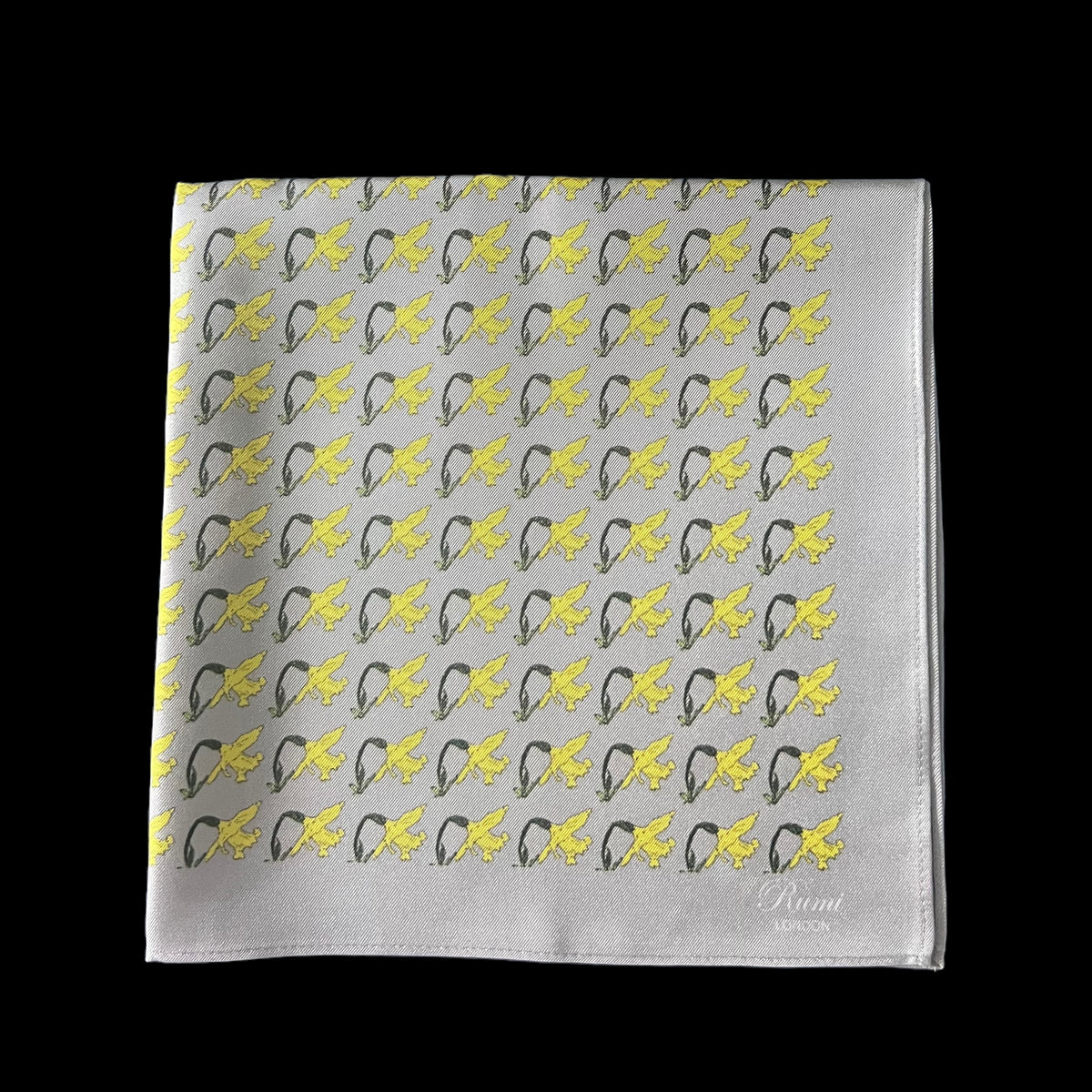 A silk pocket square featuring a repeating pattern of yellow daffodils on a dusky grey base, displayed folded against a solid black background.