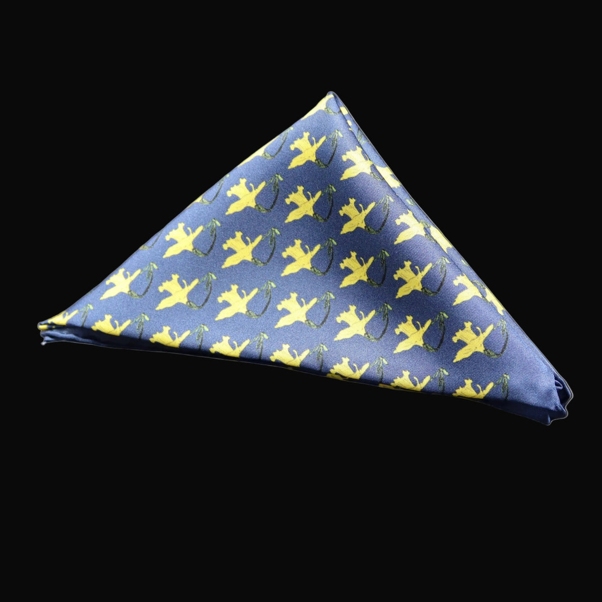 A blue pocket square with a repeat pattern of yellow daffodils on a deep blue base, folded into a triangle.