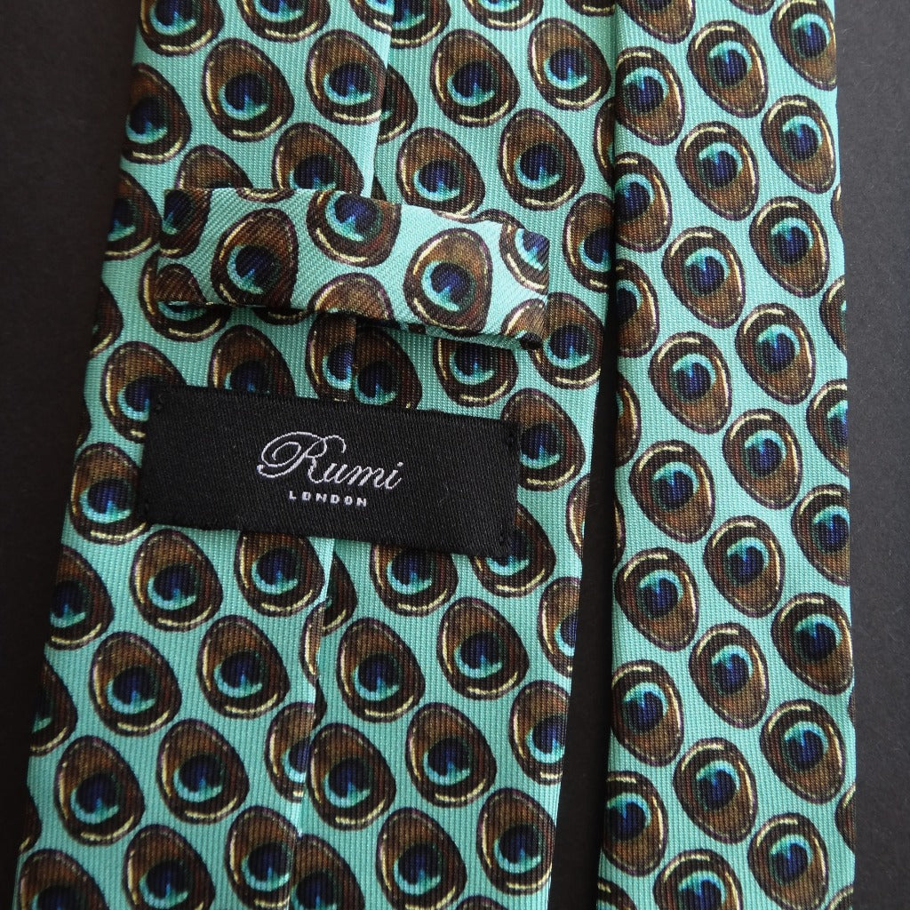Pure Silk Peacock Feather Motif Tie featuring the back with the Rumi London label .