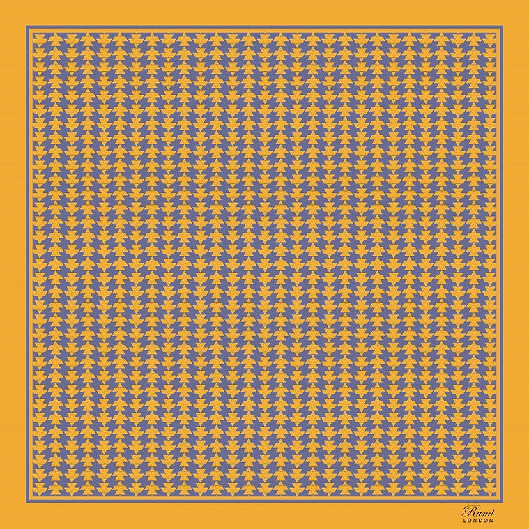 Patterned square silk scarf with blue and yellow geometric design on a yellow background, and branding 'Rumi London' in a corner.