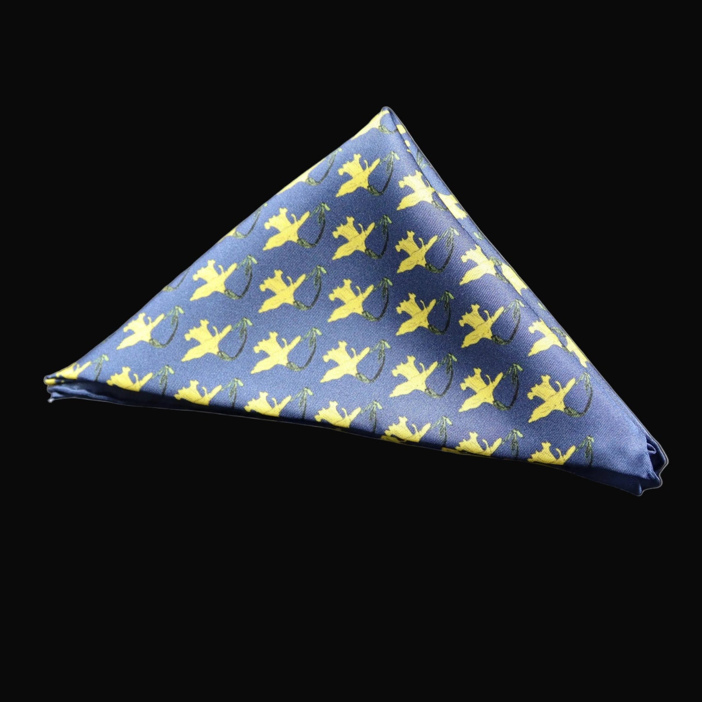 A blue pocket square with a repeat pattern of yellow daffodils on a deep blue base, folded into a triangle.
