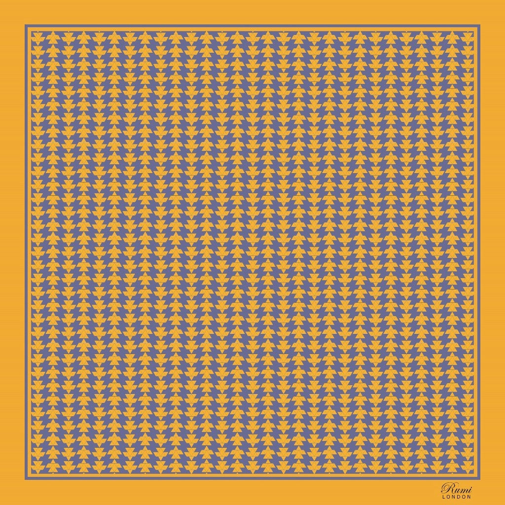 Patterned square silk scarf with blue and yellow geometric design on a yellow background, and branding 'Rumi London' in one corner.