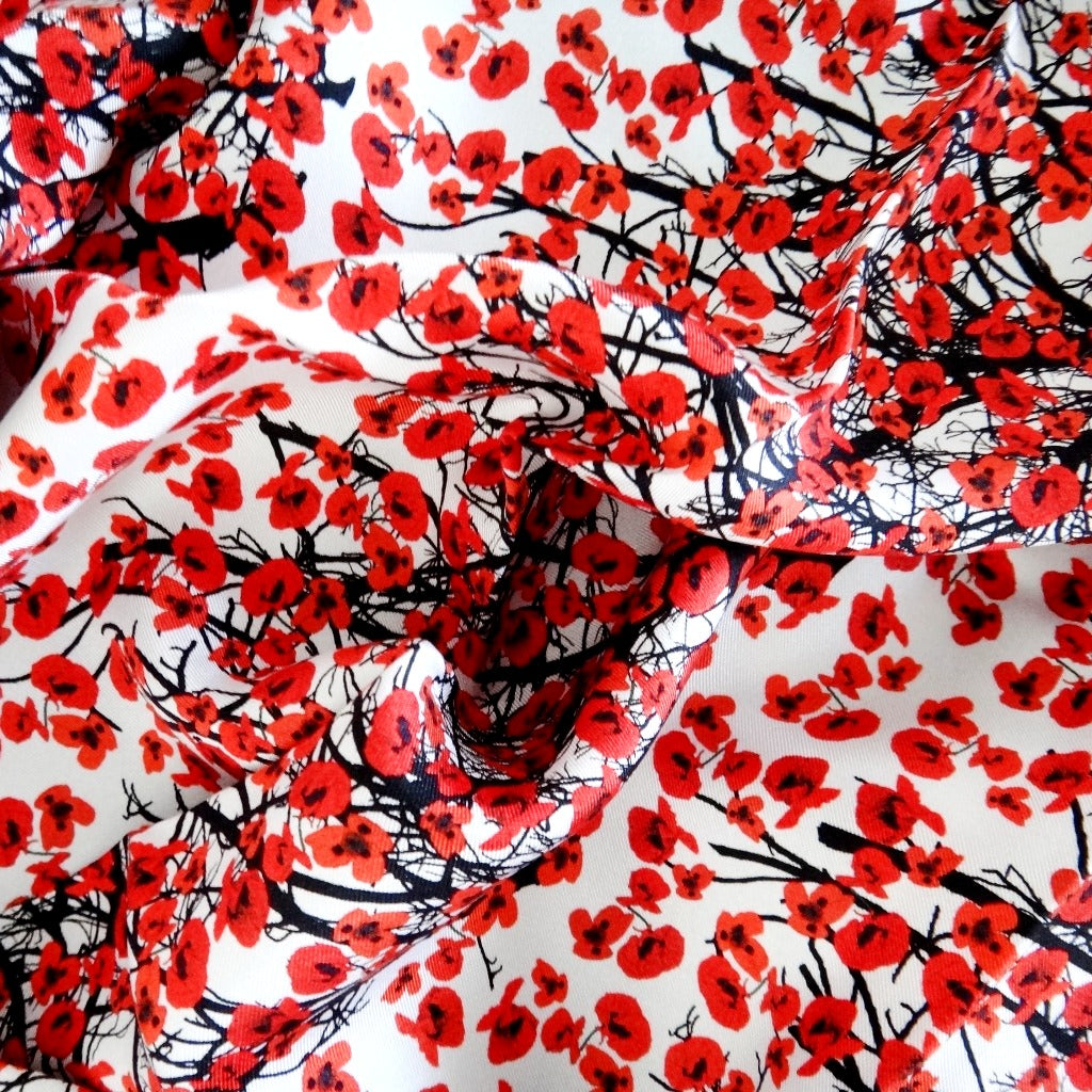 Silk scarf scattered poppies with black branches with red border.